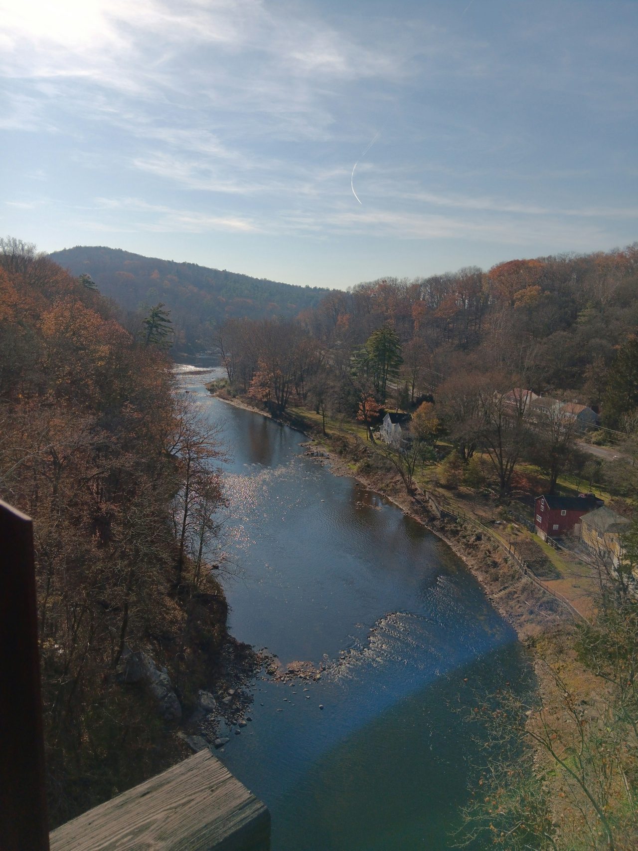 A river winding through wooded hills in autumn, the fly-fishing trout country of the Catskills
