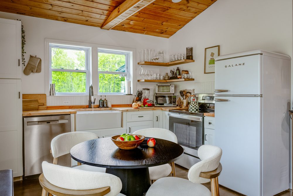 Farmhouse kitchen and dining nook with forest views