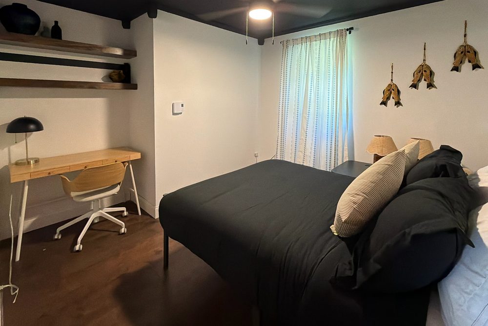 The Angler's Den: queen bedroom with a desk and fishing-themed decor
