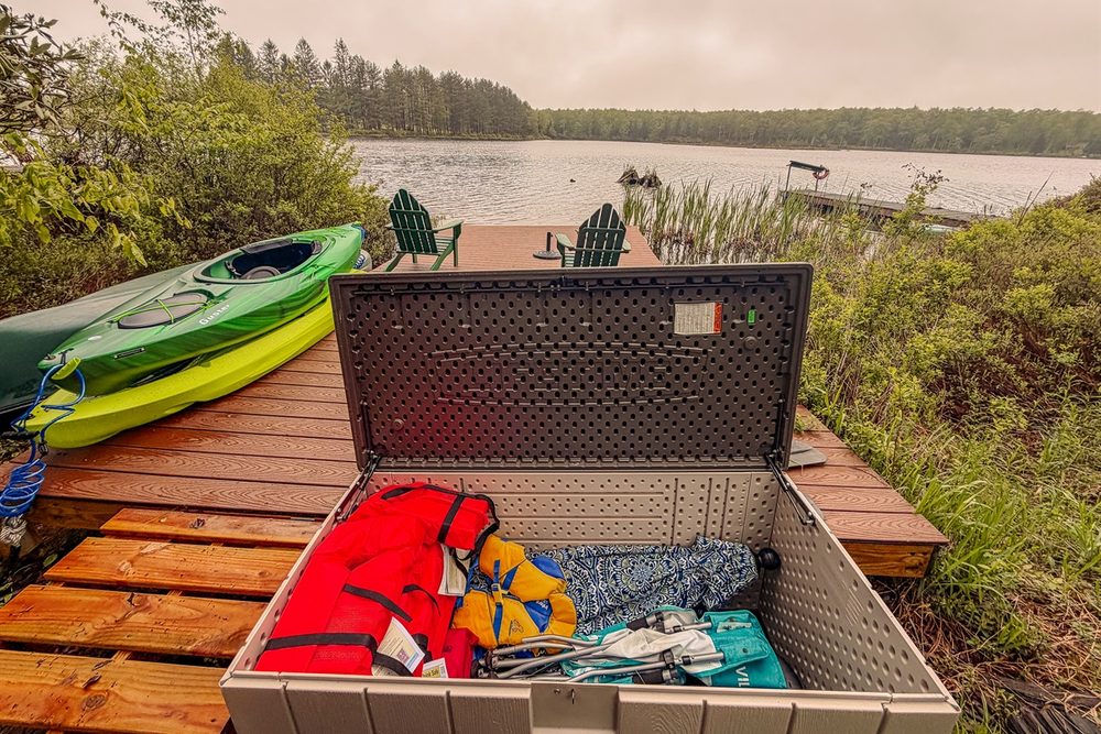 Two kayaks, life jackets and paddles ready at the private lake dock