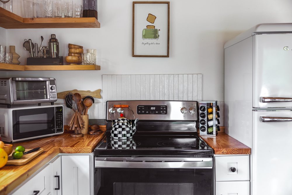 Farmhouse kitchen with a stainless range, retro fridge and open shelving