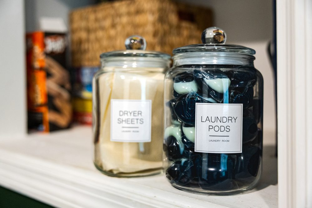 Laundry detergent and dryer sheets on a shelf