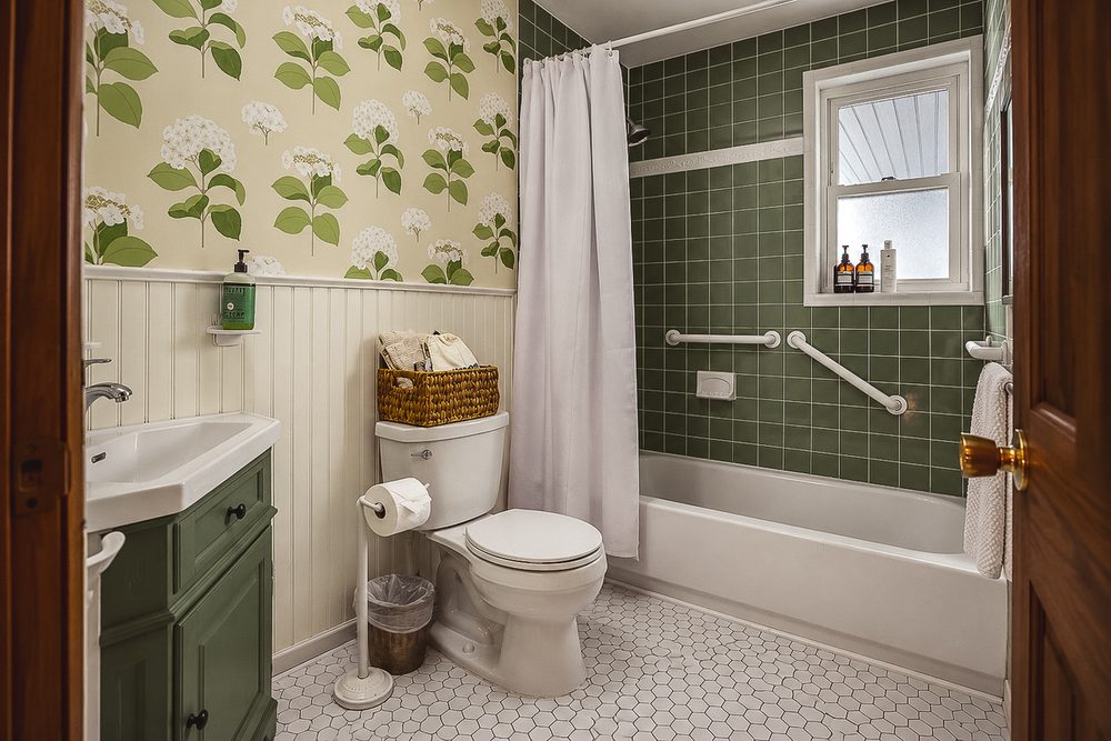Full bathroom with a shower-tub combination and botanical accents